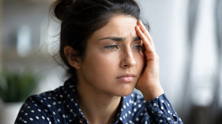 Person sitting quietly and taking a mental break after a stressful day